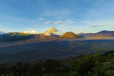 View of volcanic landscape against cloudy sky