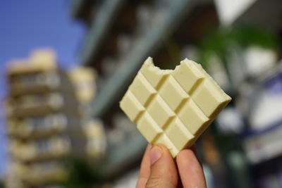 Close-up of hand holding ice cream cone