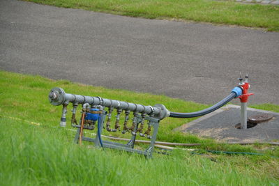 Close-up of pipeline on grassy field