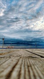 Pier on beach against sky