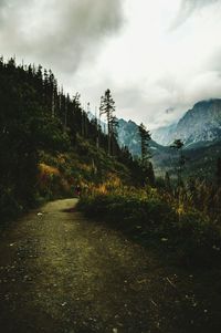 Country road against cloudy sky