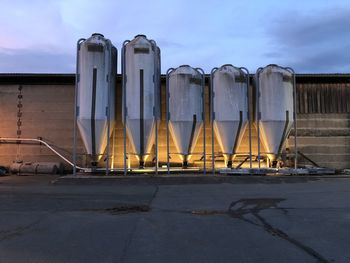 Factory against sky at sunset