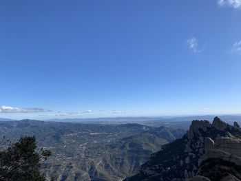 Scenic view of mountains against blue sky