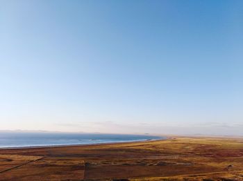 Scenic view of beach against clear blue sky