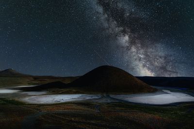 Scenic view of mountains against sky at night