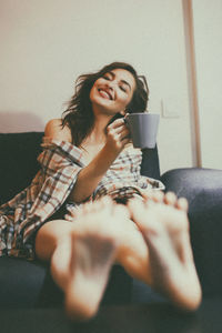 Young woman drinking coffee cup at home