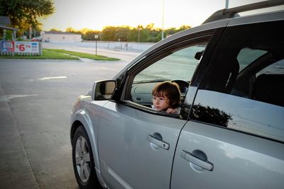 Side view of boy relaxing on road