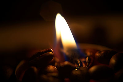 Close-up of burning candle on a coffee 