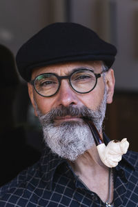 Bearded mature man smoking pipe