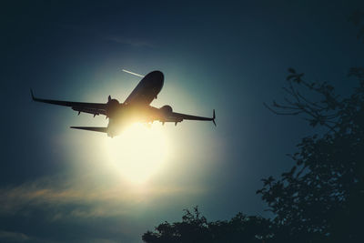 Low angle view of airplane flying against sky