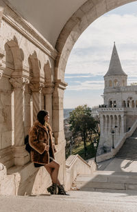 Young woman standing on steps at fisherman's bastion in budapest, hungary