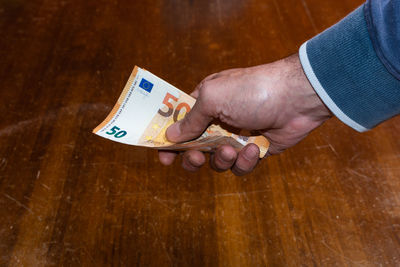 Close-up of a hand holding paper