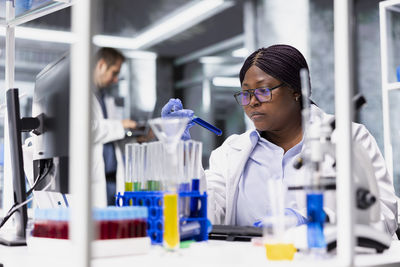 Portrait of young woman standing in laboratory
