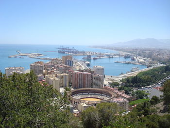 High angle view of buildings by sea against sky