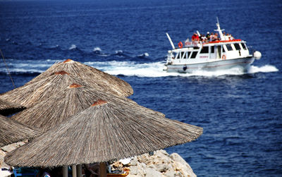 Boat sailing on sea against sky