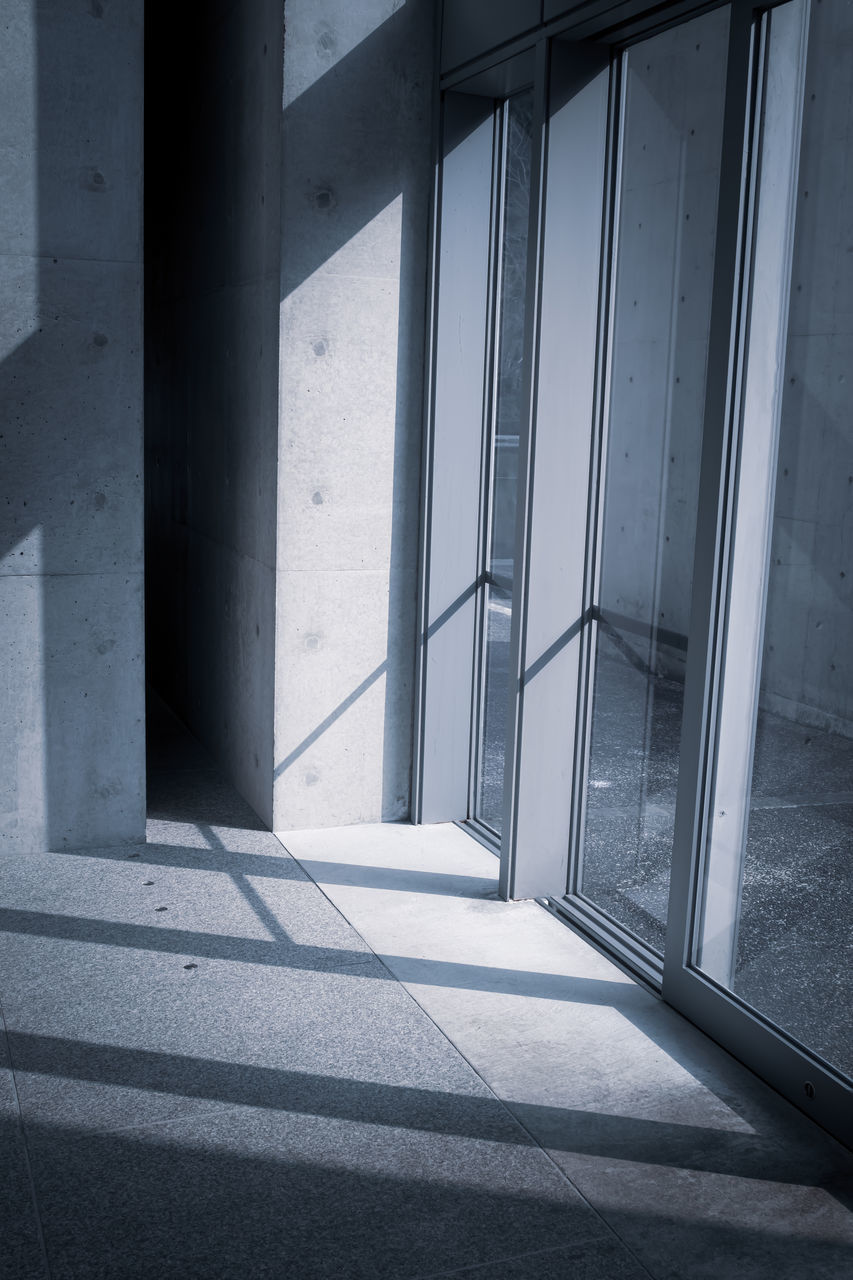 SUNLIGHT FALLING ON BUILDING SEEN THROUGH WINDOW