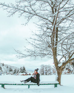 Rear view of man walking on snow covered landscape