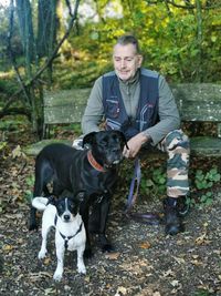 Portrait of woman with dog on field