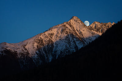 Scenic view of mountains against clear blue sky