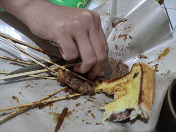 Close-up of person preparing food on table