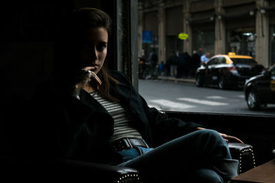 Side view of young woman looking away