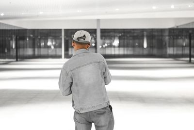Rear view of man standing in bus