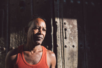 Portrait of man standing against wall