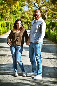 Full length of couple standing on footpath
