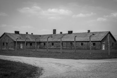 Houses on field against sky