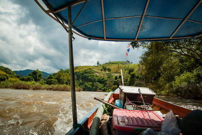 Boat in river against sky