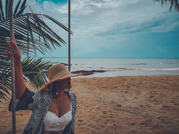 Woman on beach against sky