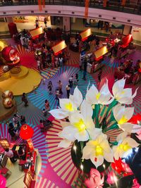 High angle view of people at illuminated market stall