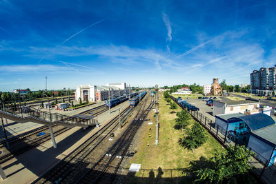 High angle view of city street against blue sky