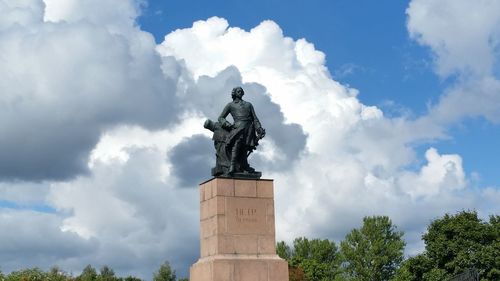 Low angle view of statue against cloudy sky