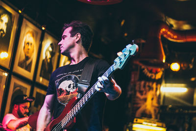 Man playing guitar at music concert