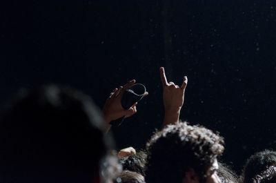 Low angle view of people enjoying at music concert