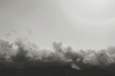 Scenic view of mountains against cloudy sky