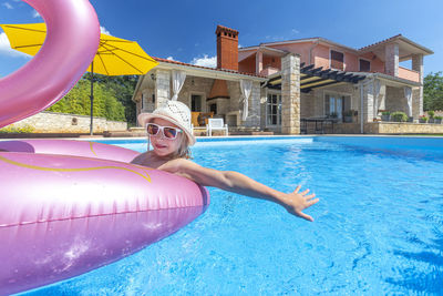 Portrait of woman swimming in pool