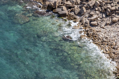 High angle view of water flowing through rocks