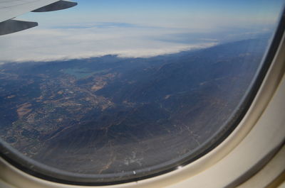 Aerial view of landscape seen through airplane window