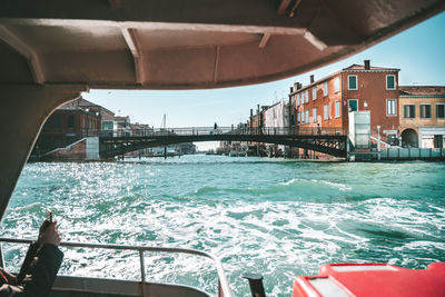 Bridge over river against buildings in city