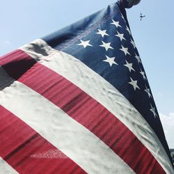 Low angle view of flag against sky