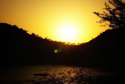 Scenic view of silhouette mountains against sky during sunset