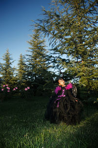 Rear view of woman walking on field