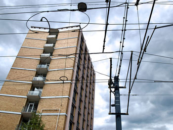 Low angle view of electricity pylon against sky