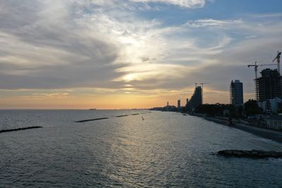 View of buildings against cloudy sky during sunset