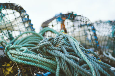 Close-up of tied rope and crab pots