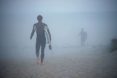 Full length of woman standing in water