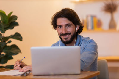 Young business man working with laptop. gray notebook for working. home office . 