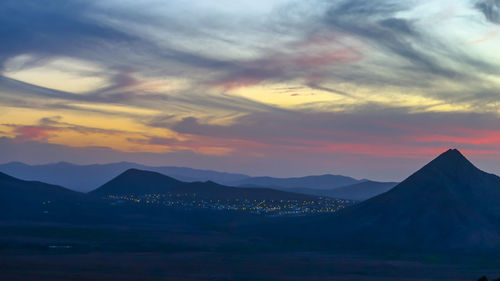 Scenic view of silhouette mountains against sky during sunset